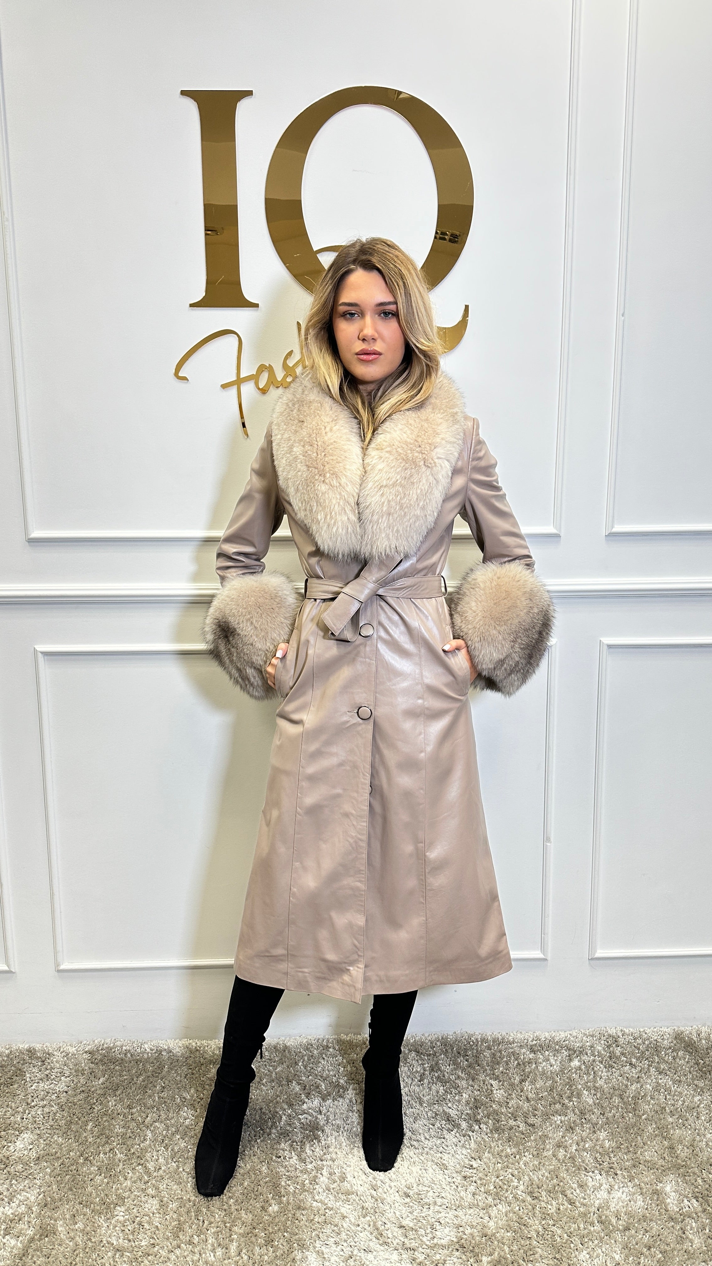 Beige leather coat by iqfashioncluj, Antheea blanuri style, shown on a hanger with detailed leather texture.