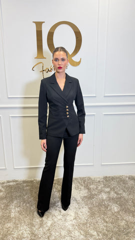 Black Anais costume by ELVE STYLE SRL with gold button details, featuring elegant design and decorative gold buttons.