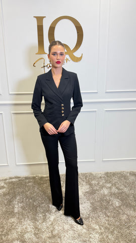 Black costume with gold buttons by ELVE STYLE SRL, featuring detailed embellishments and elegant design.