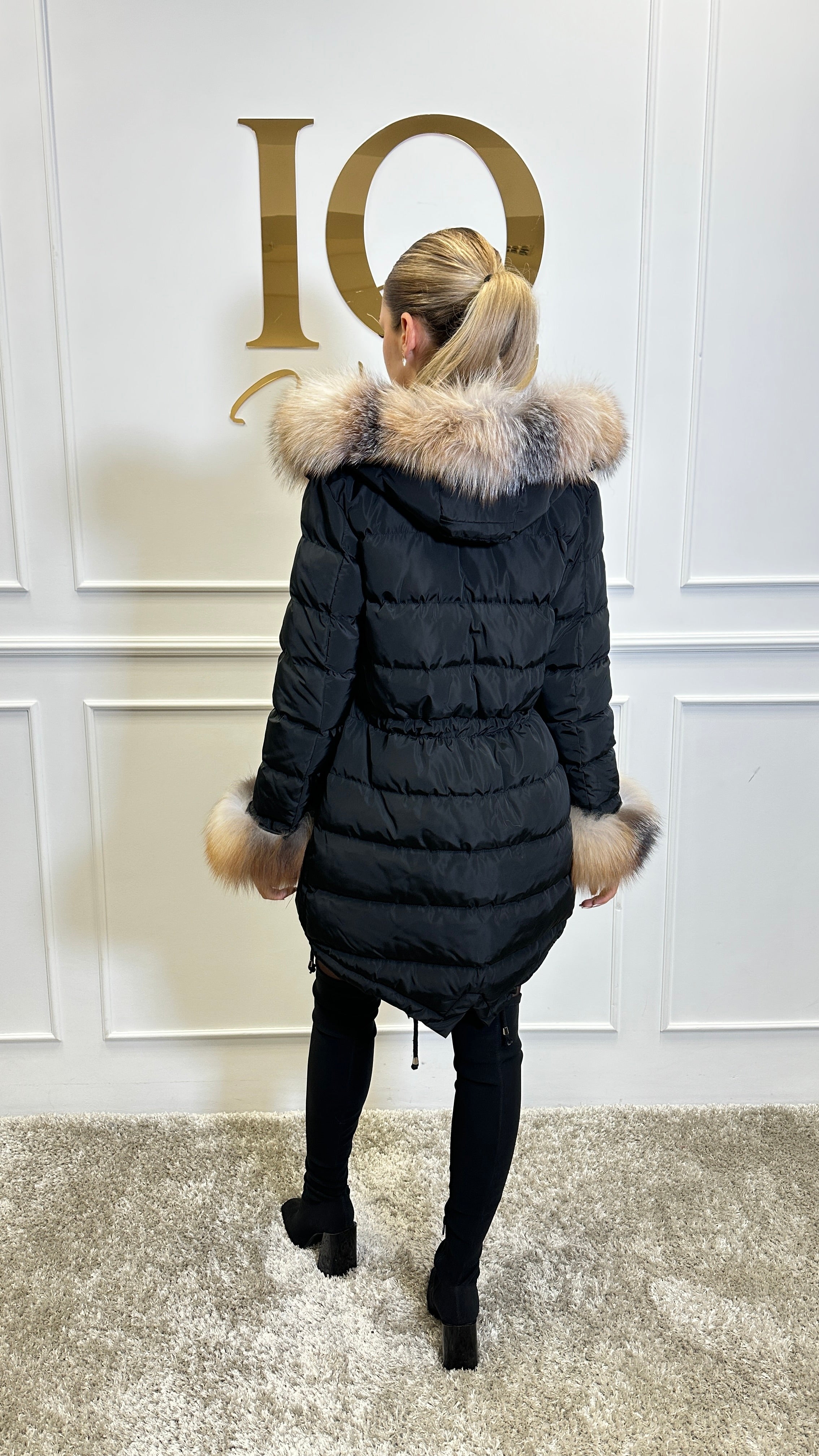Black and gold ELVE STYLE SRL parka featuring a stylish design and cozy hood, perfect for cold weather outings.